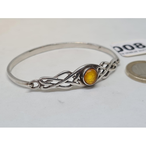 8 - Sterling silver Celtic bangle with amber stone.