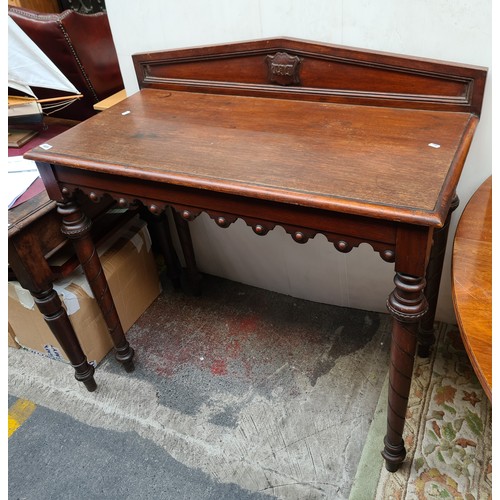 489 - Victorian pitched mahogany gallery backed console table. Lovely piece.