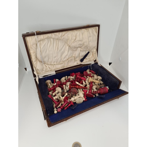 50 - Two 19th century mixed ivory chess sets. Approx 35 pieces in a box.