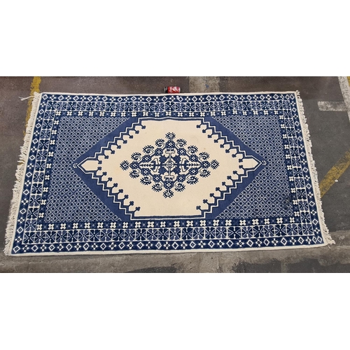 641 - Blue and White handmade Persian floor rug. Approx 7 feet x 5 feet, Thick and heavy, Persian label on... 