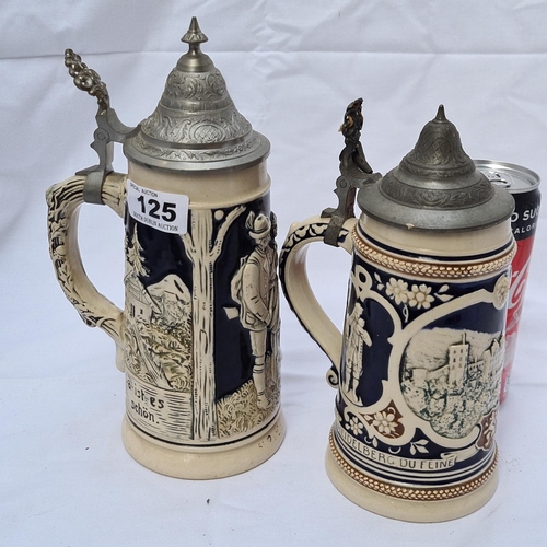 125 - Pair of German ceramic and metal lidded steins, one Auf der Alm (#480) and the other Heidelberg (#20... 