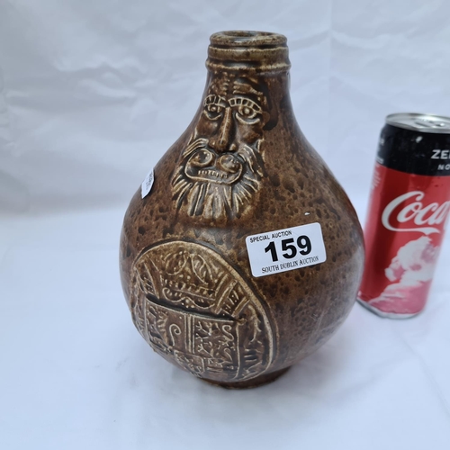 159 - Earthenware ale jug with kings crest and bearded faced man to the front. Unusual piece