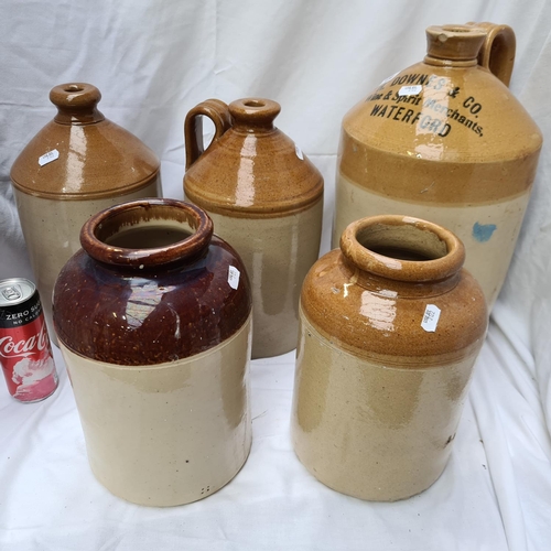 234 - Stoneware large glazed jug, H Downes & Co Wine and Spirit Merchant, Waterford and 4 other salt glaze... 