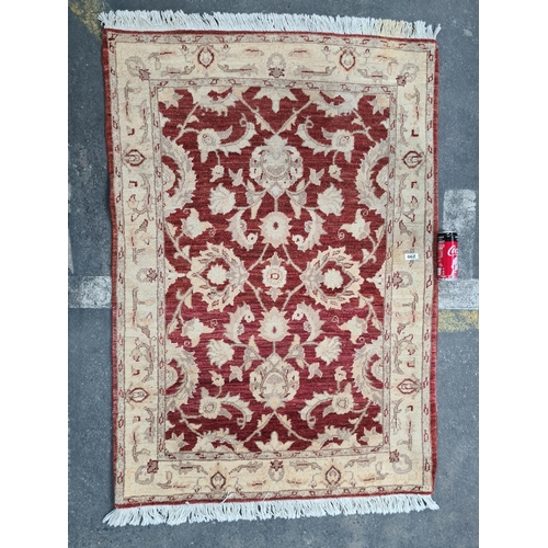 290 - Persian Handmade Floor rug in reds and whites. 99cm x 140 cm