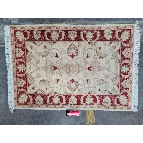 291 - Persian Handmade Floor rug in reds and whites. 99cm x 140 cm