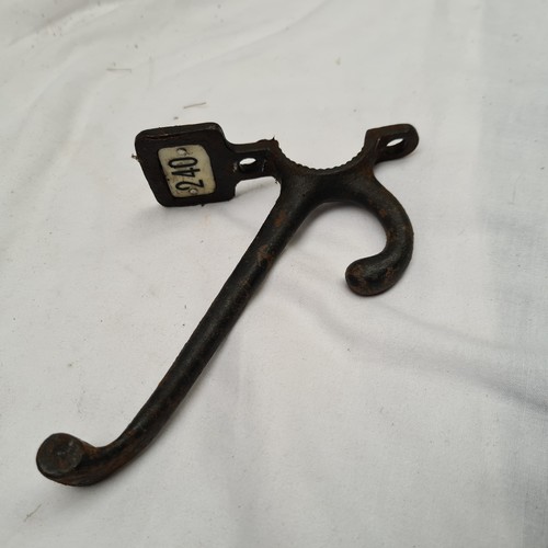 132 - Large double upper and lower coat hooks, cast metal and each has a ceramic number