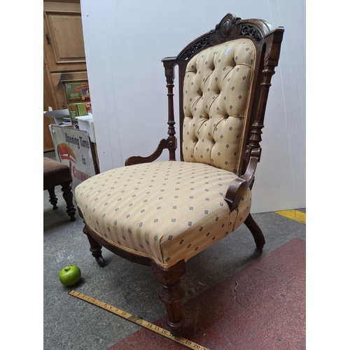 376 - Victorian mahogany button back chair with castors and gold upholstering. 90cm tall. In very good con... 