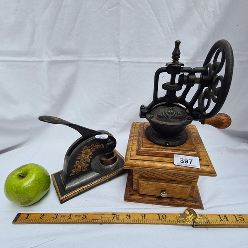 397 - Grinder with visible mechanism and a paper embosser / stamp, 'Limited'.