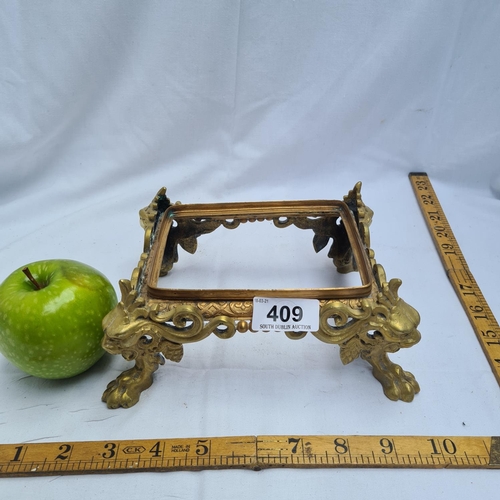 409 - Heavy brass stand with lion's feet.