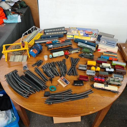 683 - Large collection of more than 100 model train  items including engines, carriages, tracks, bridges e... 