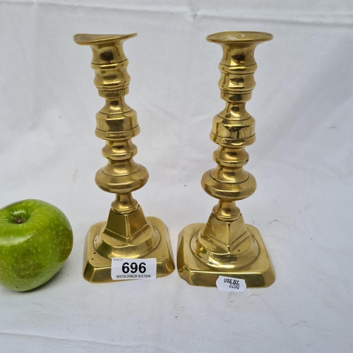 696 - Two brass candlesticks