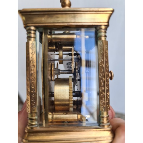 69 - Elliot & son, miniature  carriage clock. With incised floral detail and glass sides to see the mecha... 