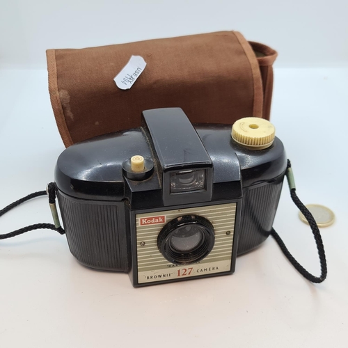 414 - Kodak Insta Camera and a Kodak Brownie 127 camera in soft case.