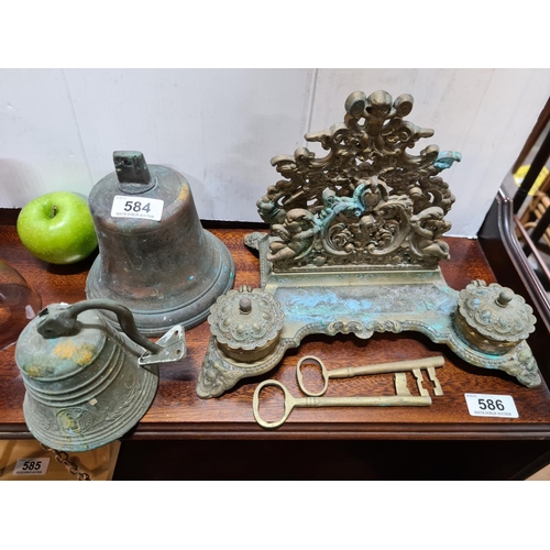 584 - 5 pieces including two brass heavy antique  bells, a pair of brass keys and a heavy ornate brass ink... 