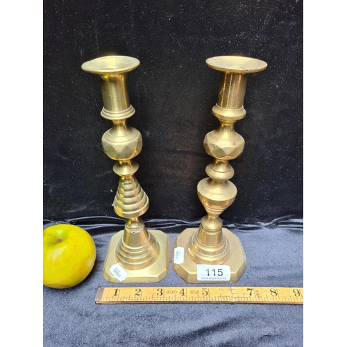 115 - Pair of Edwardian brass candlesticks. 9.5 inches (h) each.