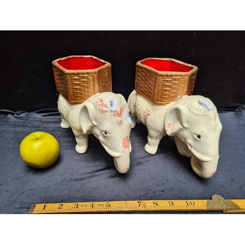 118 - Pair of ornamental elephant statuettes featuring storage basket on top.
