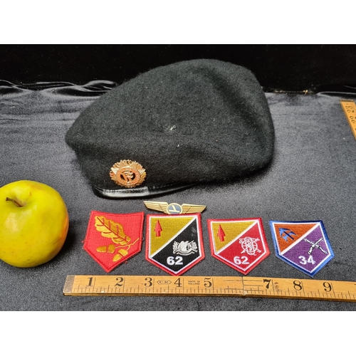 138 - Irish army beret with cap badge and four arm flashes.