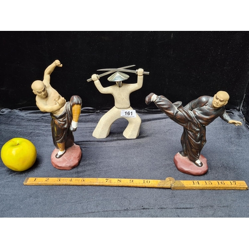 161 - Set of three martial arts statuettes. 8 inches (h).