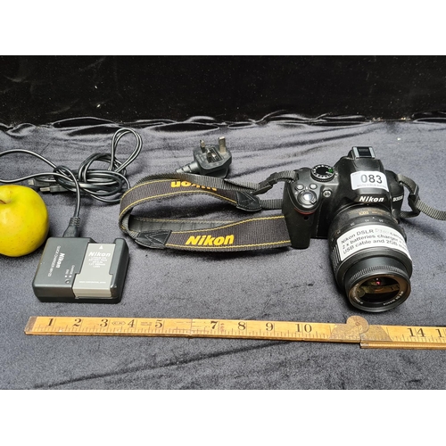 83 - Nikon DSLR D3000 camera with DX18-55mm lens. Appears to be in excellent condition. Includes 2 batter... 