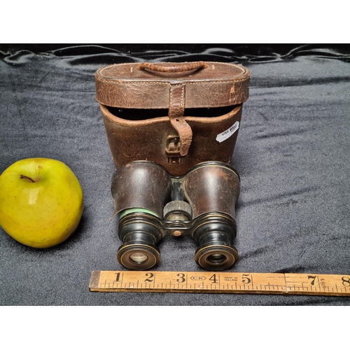 92 - Antique field glasses in brown leather case. (one of the leather holders needs to be glued.)