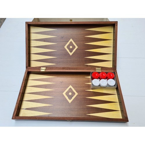 241 - A large as new table backgammon set. Heavy in a nice wooden travel case.