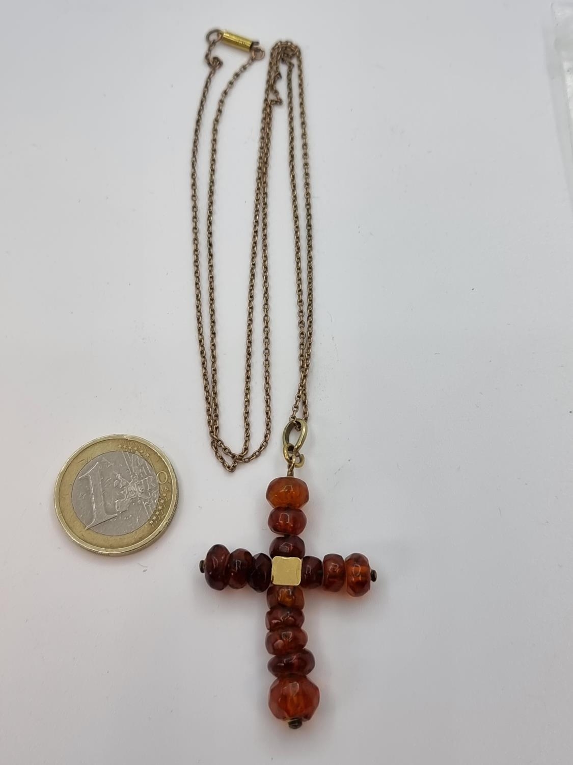 9 carat gold Ciro amber cross pendant. Weight of gold 2.6g. Super