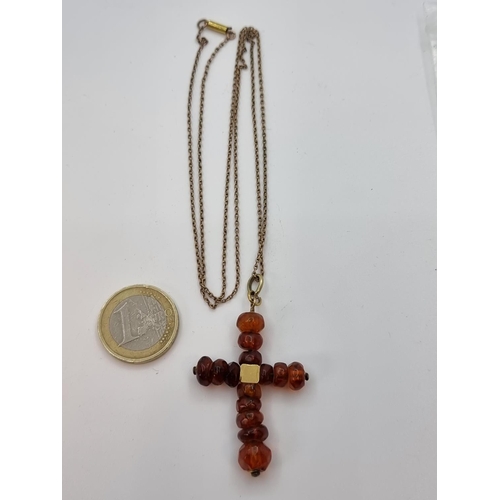 24 - 9 carat gold Ciro amber cross pendant. Weight of gold, 2.6g. Super Amber cross.