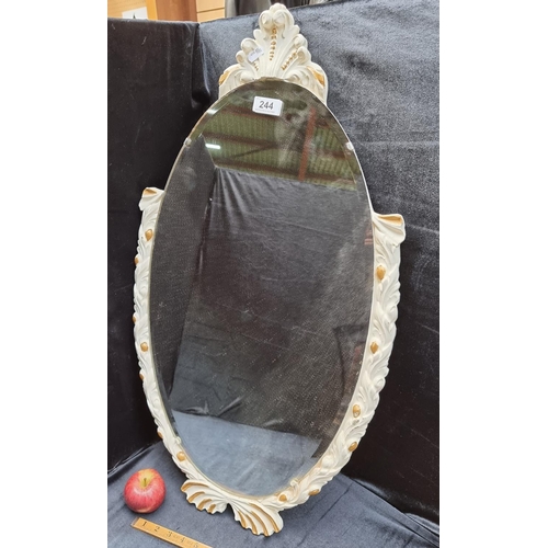 244 - Oval bevelled wall mirror with ornate frame