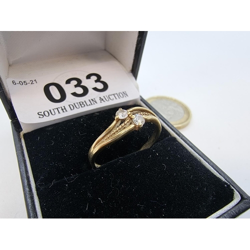 33 - 9 carat gold, twist design two stone gemset ring. Size M,
