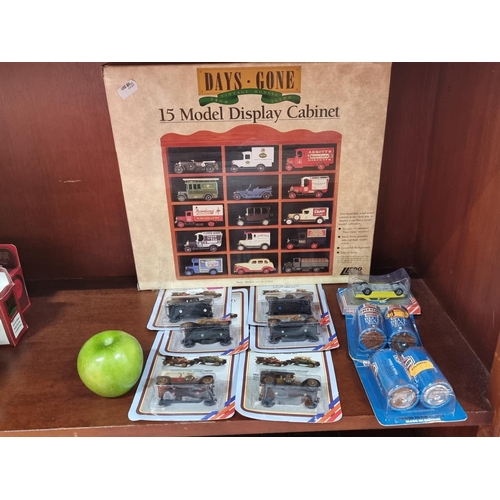 546 - Days Gone fifteen model display cabinet, new in box. Including, seven model cars new in box.