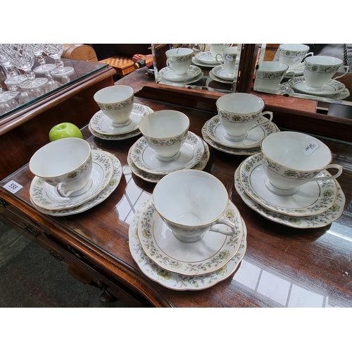 556 - China tea set featuring eighteen pieces in total, with floral pattern.