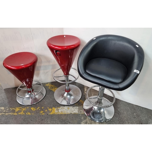 569 - Three items including faux leather swivel stool with low raised back and pair of matching red swivel... 