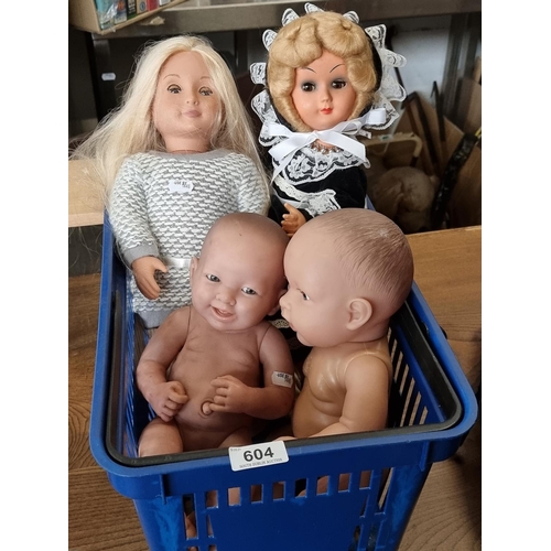 604 - Collection of four dolls including two lifelike babydoll.