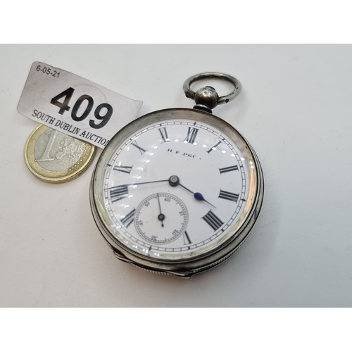 409 - A hallmarked Sterling silver pocket watch with porcelain and Roman numeral front with engine turned ... 