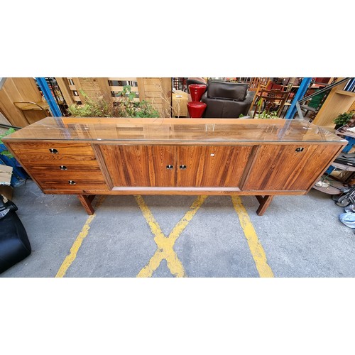 299 - Mid Century Rosewood sideboard with three drawers and two cupboards and a glass saver top. . Mm: 220... 