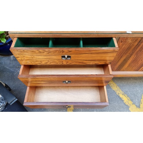 299 - Mid Century Rosewood sideboard with three drawers and two cupboards and a glass saver top. . Mm: 220... 