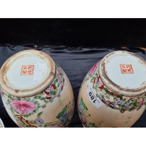 189 - A pair of ornately hand painted famille rose Chinese vases, With 4 character reign marks. In good or... 