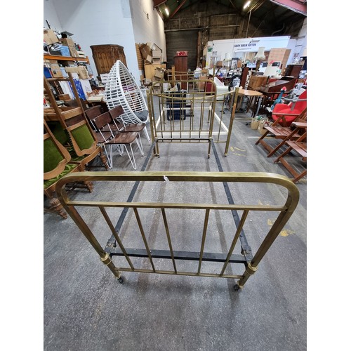 575 - Two vintage brass bed frames, including headboards, footboards (on wheels) and rails. 136cm wide and... 