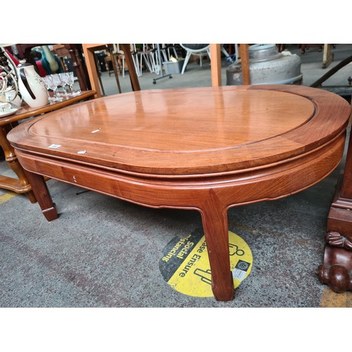 660 - An Oval Rose Wood Coffee Table, in The Chinese Style.