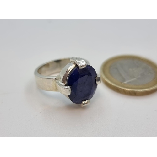 48 - Sterling silver Sapphire stone ring in claw setting, 6.5 carats. Weight 6.6g, size L.