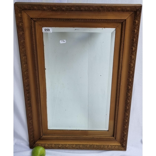 59 - Large bevelled mirror with ornate frame.