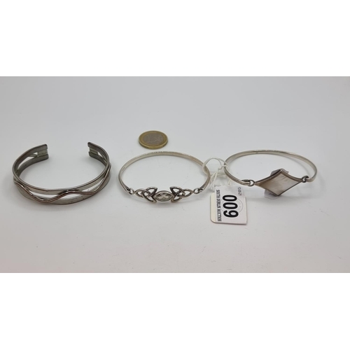 9 - Three sterling silver torc bracelets, one with diamond shaped mother of pearl centre, the other feat... 