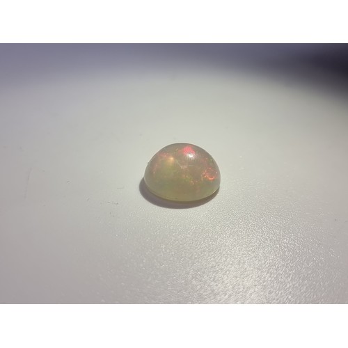 42 - A white opal cabachon of 7.99 carats with ITLRG gem certificate.