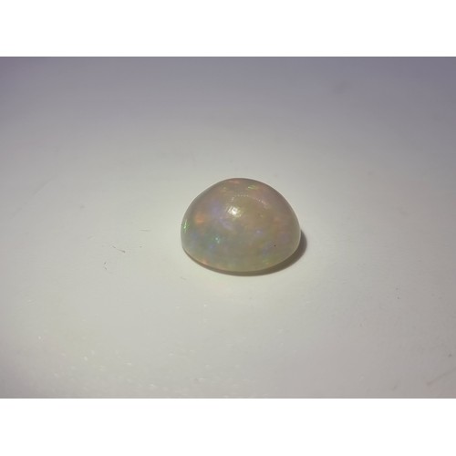 42 - A white opal cabachon of 7.99 carats with ITLRG gem certificate.