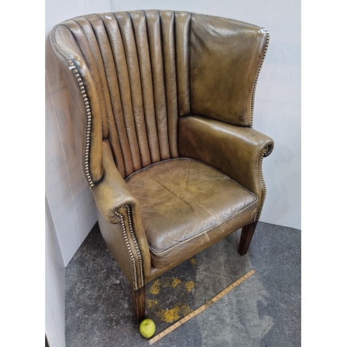555 - Star Lot : Fabulous antique high winged backed porters style chair with fine grain green leather, St... 