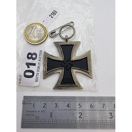 18 - A metal German Iron Cross medallion, dated 1813. To reverse features a swastika with date 1939 below... 