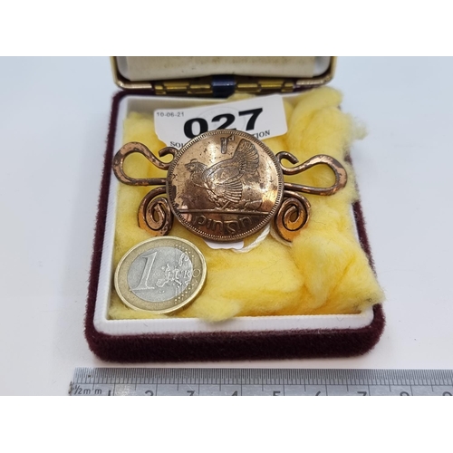 27 - A scroll designed brooch with an Irish 1d penny coin centre mount. Clasp in good condition.
