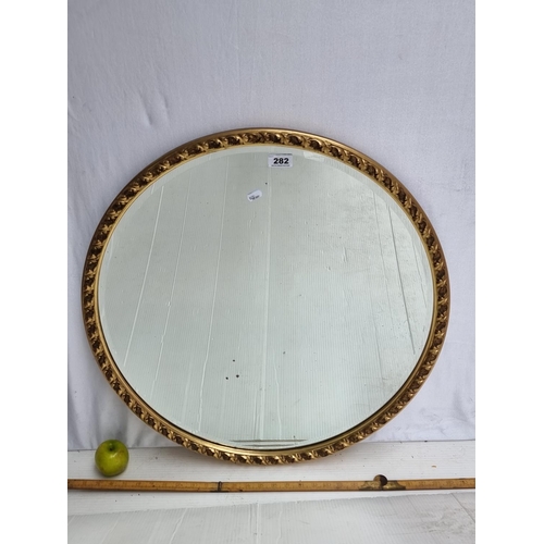 282 - A Large beautiful, circular bevelled Mirror with a foliate Gilt Frame. Very nice, heavy quality mirr... 