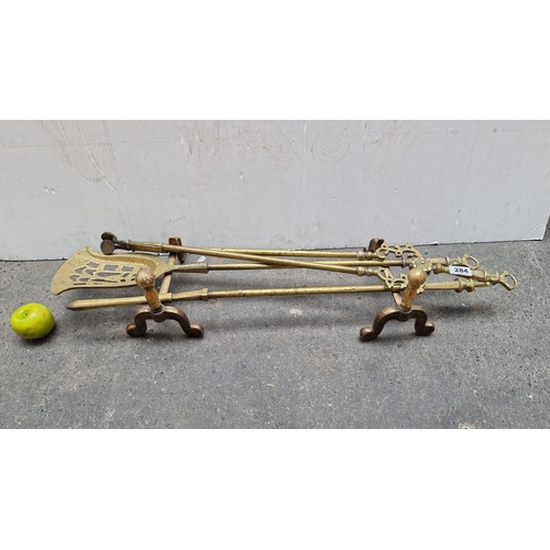 284 - A good set of Victorian pierced fire irons and fire dogs. Heavy good quality.