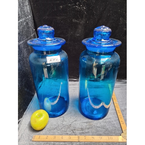 299 - 2 Large green antique blue  Glass chemist Jars with Flower Motif on The Lid. In good order. Super lo... 